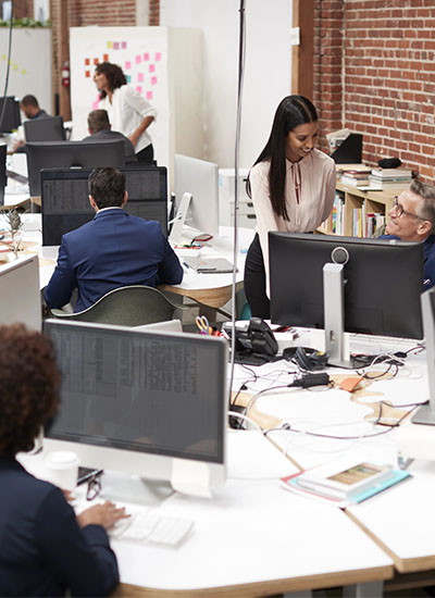 Japanese business professionals collaborating in an office with optimized WiFi performance, ensuring seamless connectivity and increased productivity